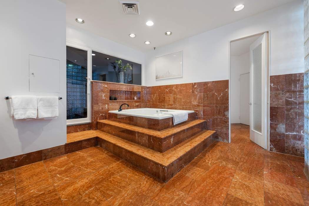 30 West 15th Street, Unit 6S Manhattan, NY 10011 - Photo 17 of 21 a bedroom with a bed and a mirror