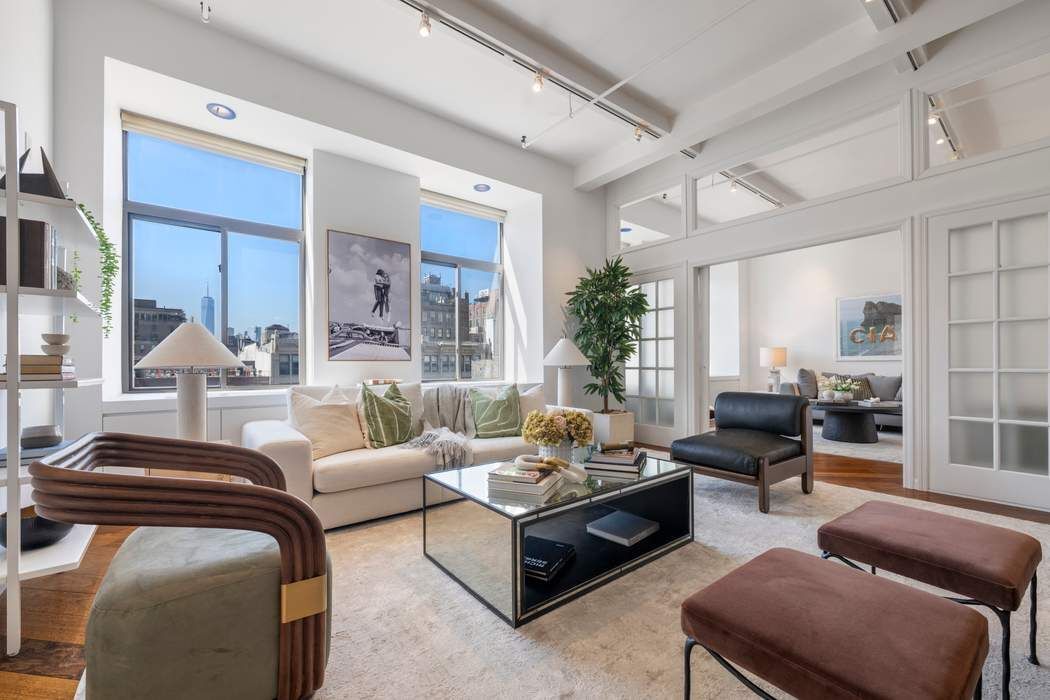 30 West 15th Street, Unit 6S Manhattan, NY 10011 - Photo 2 of 21 a living room with furniture and a large window