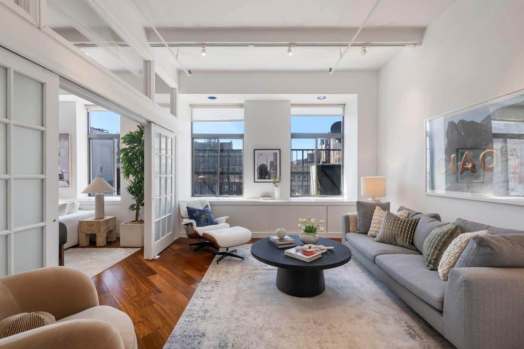 30 West 15th Street, Unit 6S Manhattan, NY 10011 - Photo 3 of 21 a living room with furniture and a large window