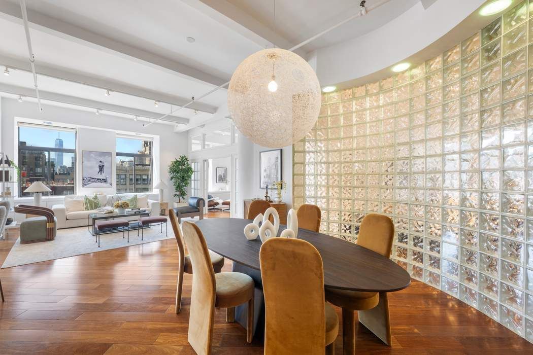 30 West 15th Street, Unit 6S Manhattan, NY 10011 - Photo 4 of 21 a view of a dining room with furniture wooden floor and a chandelier