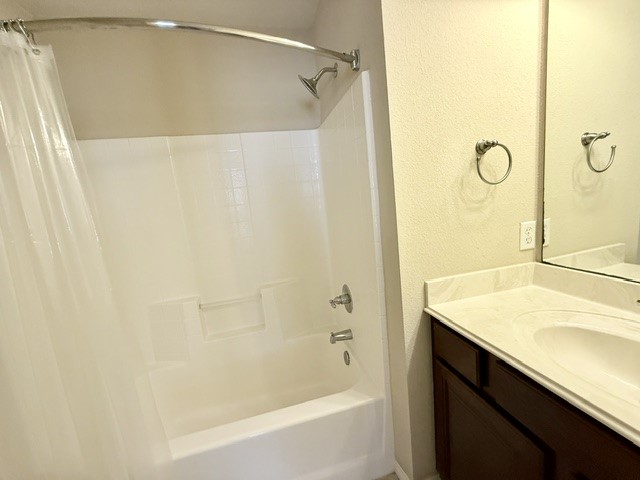 1000 Spring Loop, Unit 1806 College Station, TX 77840 - Photo 15 of 33 a bathroom with a shower curtain and a sink