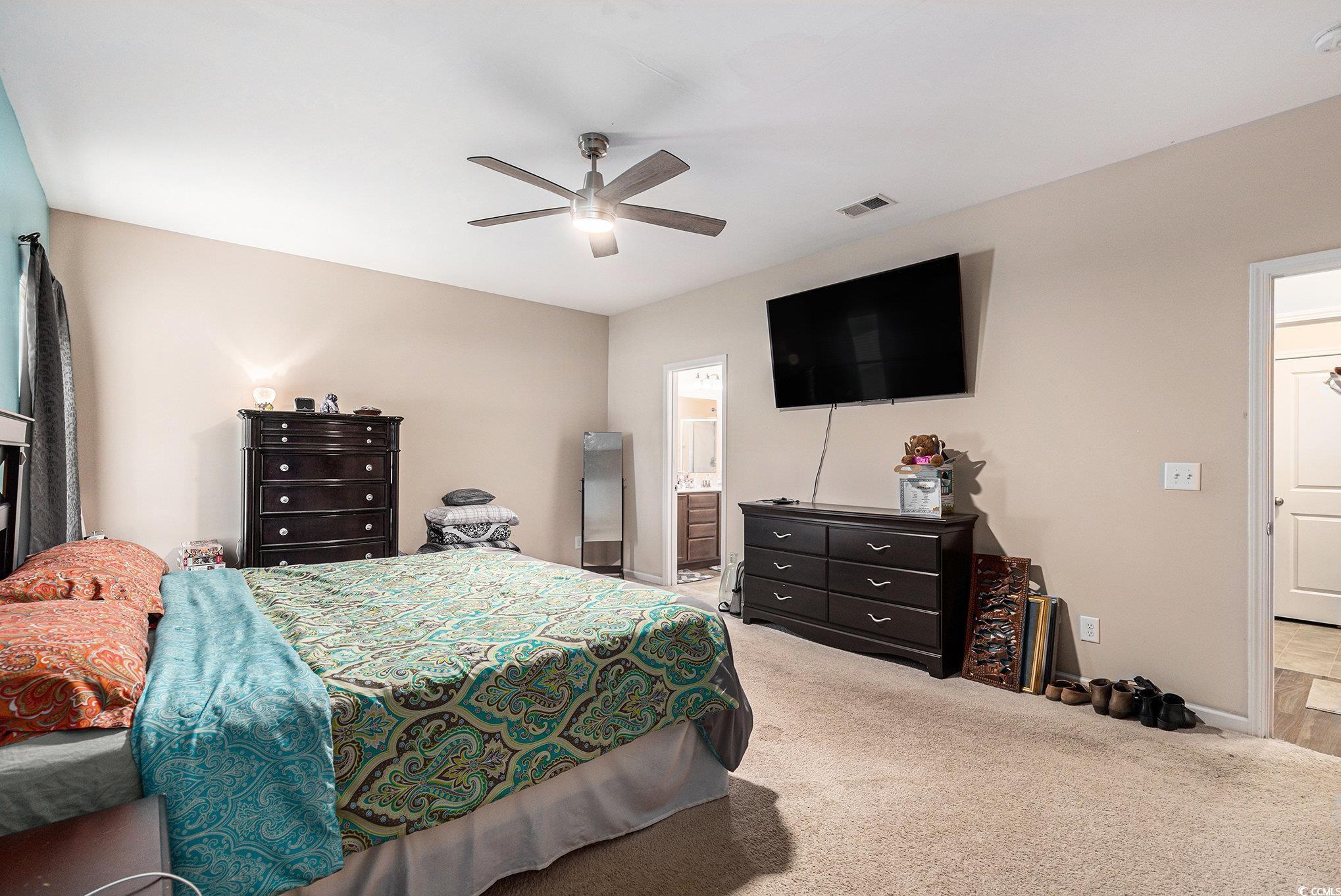 436 Cotton Grass Drive Loris, SC 29569 - Photo 15 of 33 Carpeted bedroom featuring ceiling fan, baseboards, and ensuite bathroom