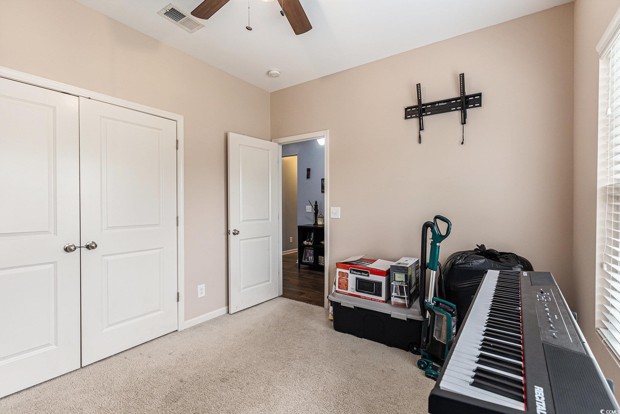 436 Cotton Grass Drive Loris, SC 29569 - Photo 18 of 33 Miscellaneous room with a ceiling fan, carpet floors, and baseboards