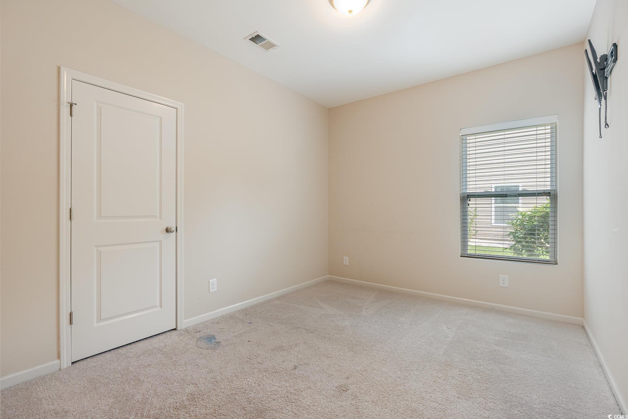 436 Cotton Grass Drive Loris, SC 29569 - Photo 20 of 33 Empty room featuring light carpet and baseboards