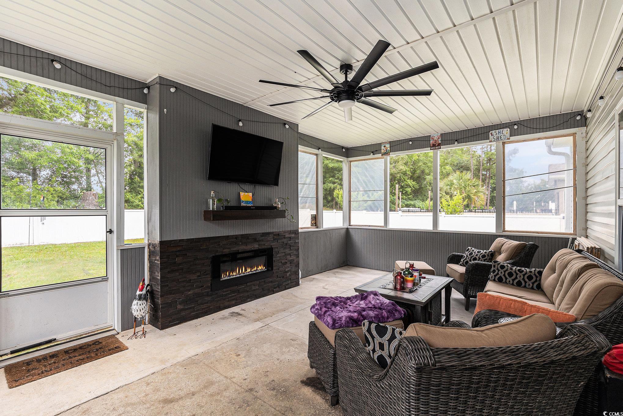 436 Cotton Grass Drive Loris, SC 29569 - Photo 23 of 33 Sunroom / solarium with an outdoor living space with a fireplace and ceiling fan