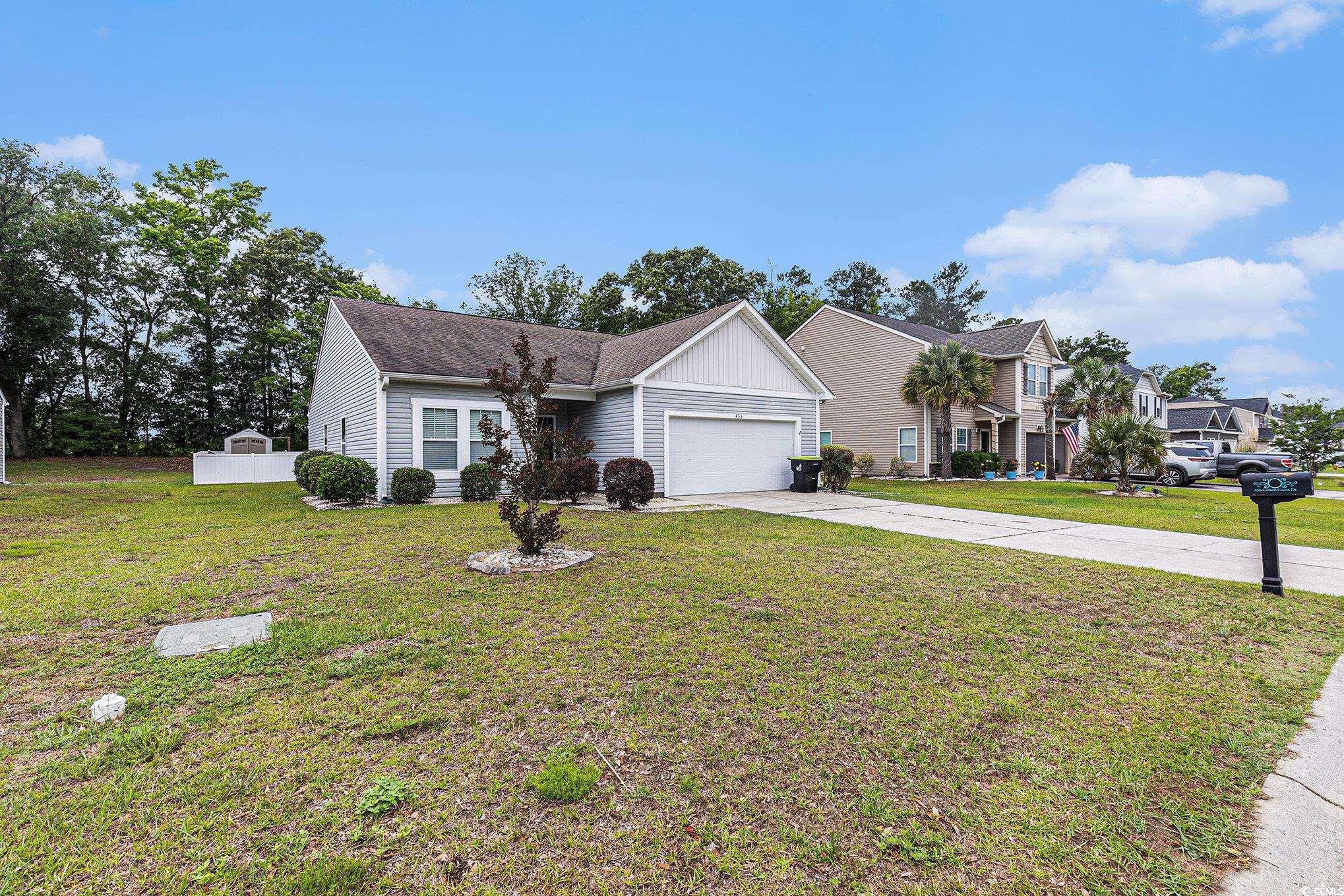 436 Cotton Grass Drive Loris, SC 29569 - Photo 29 of 33 View of front of house featuring concrete driveway, an attached garage, a front yard, and roof with shingles