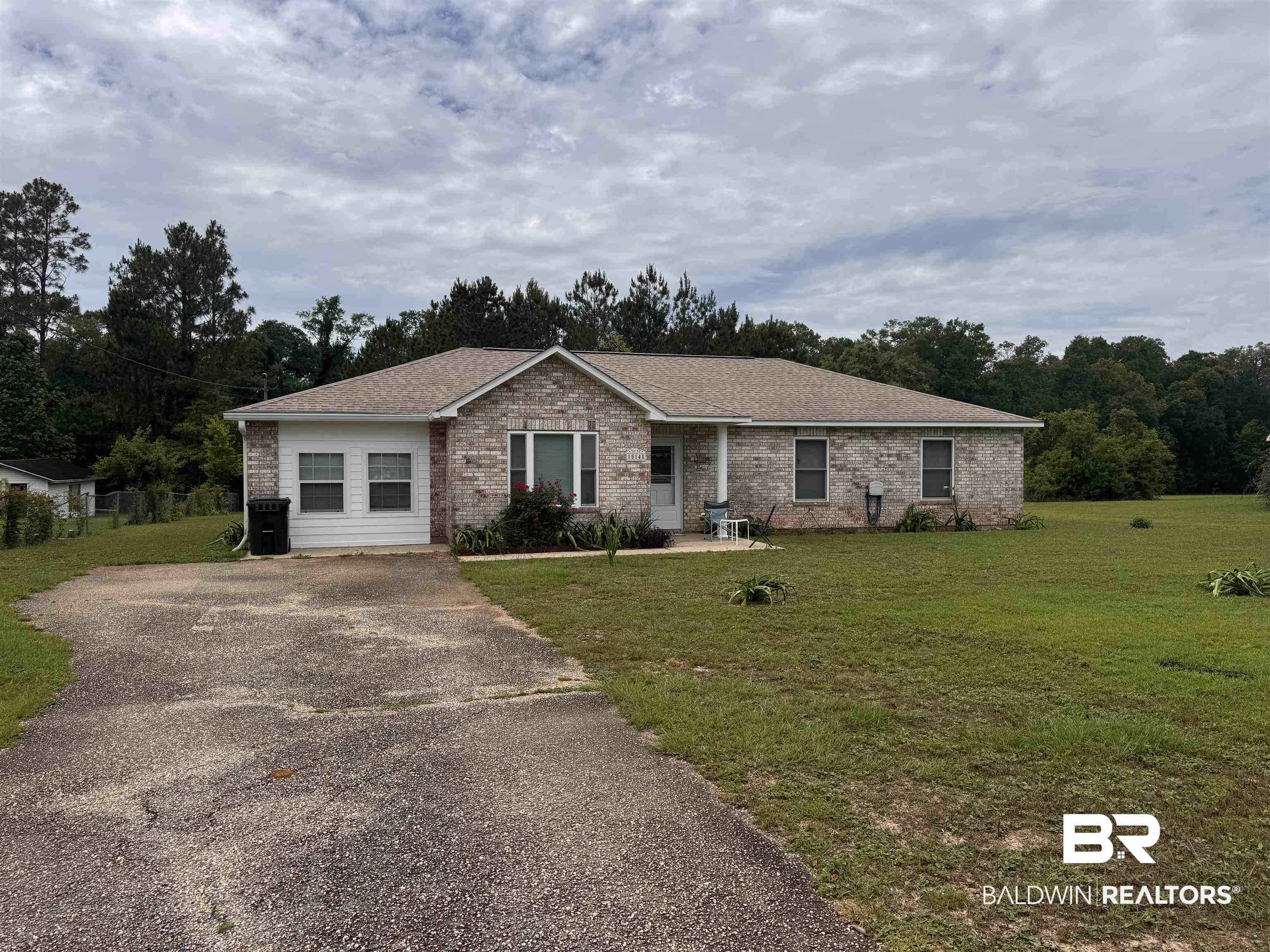 15148 Highland Circle Foley, AL 36535 - Photo 1 of 47 Ranch-style house with a front lawn, brick siding, a shingled roof, and driveway