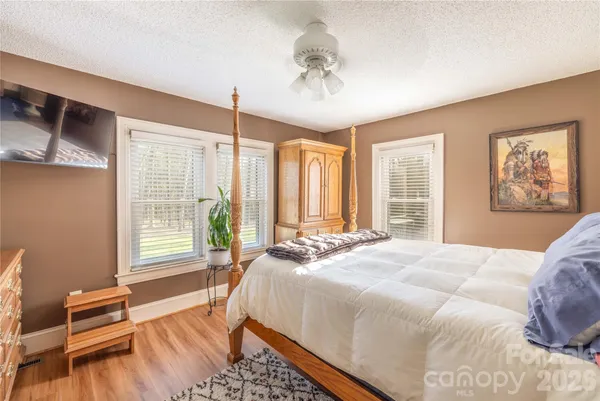a bed room with a bed mirror and a window