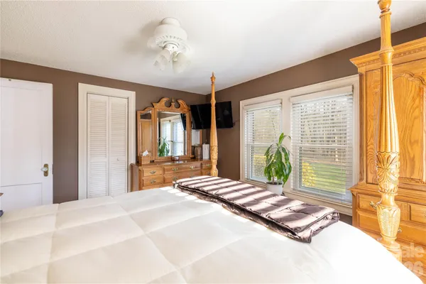 a bedroom with a bed and a mirror
