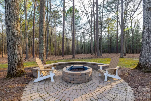 a view of a patio with couches chairs and a fire pit