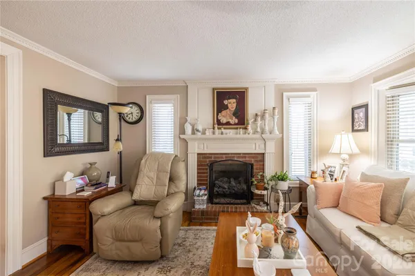 a living room with furniture fireplace and a table