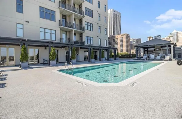 a swimming pool with outdoor seating and yard