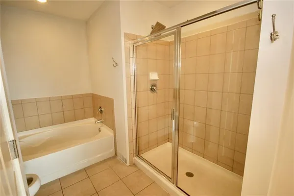 a bathroom with a bathtub and a shower
