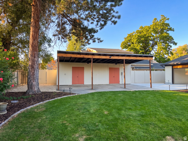 1860 Spring Lane Holladay, UT 84117 - Photo 25 of 32 Expansive lawn with concrete patio, mature tree, and privacy fencing