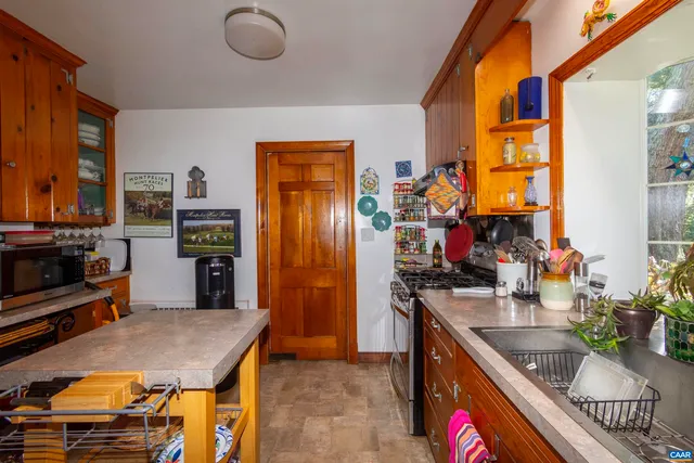 a kitchen with stainless steel appliances granite countertop a stove a sink dishwasher and cabinets with wooden floor