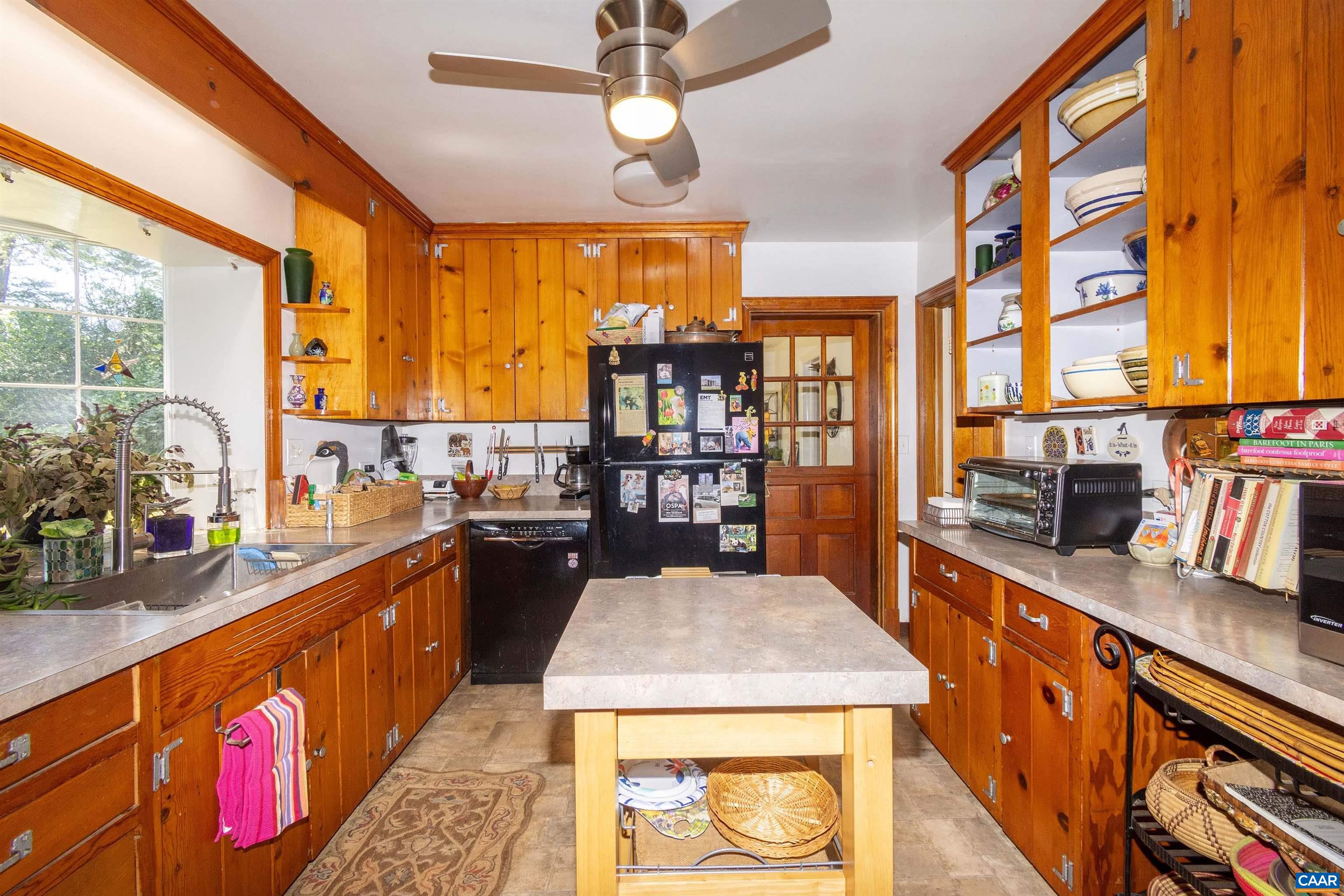 358 East Main Street Orange, VA 22960 - Photo 15 of 56 a kitchen with stainless steel appliances granite countertop a stove a sink dishwasher and a dining table with wooden floor