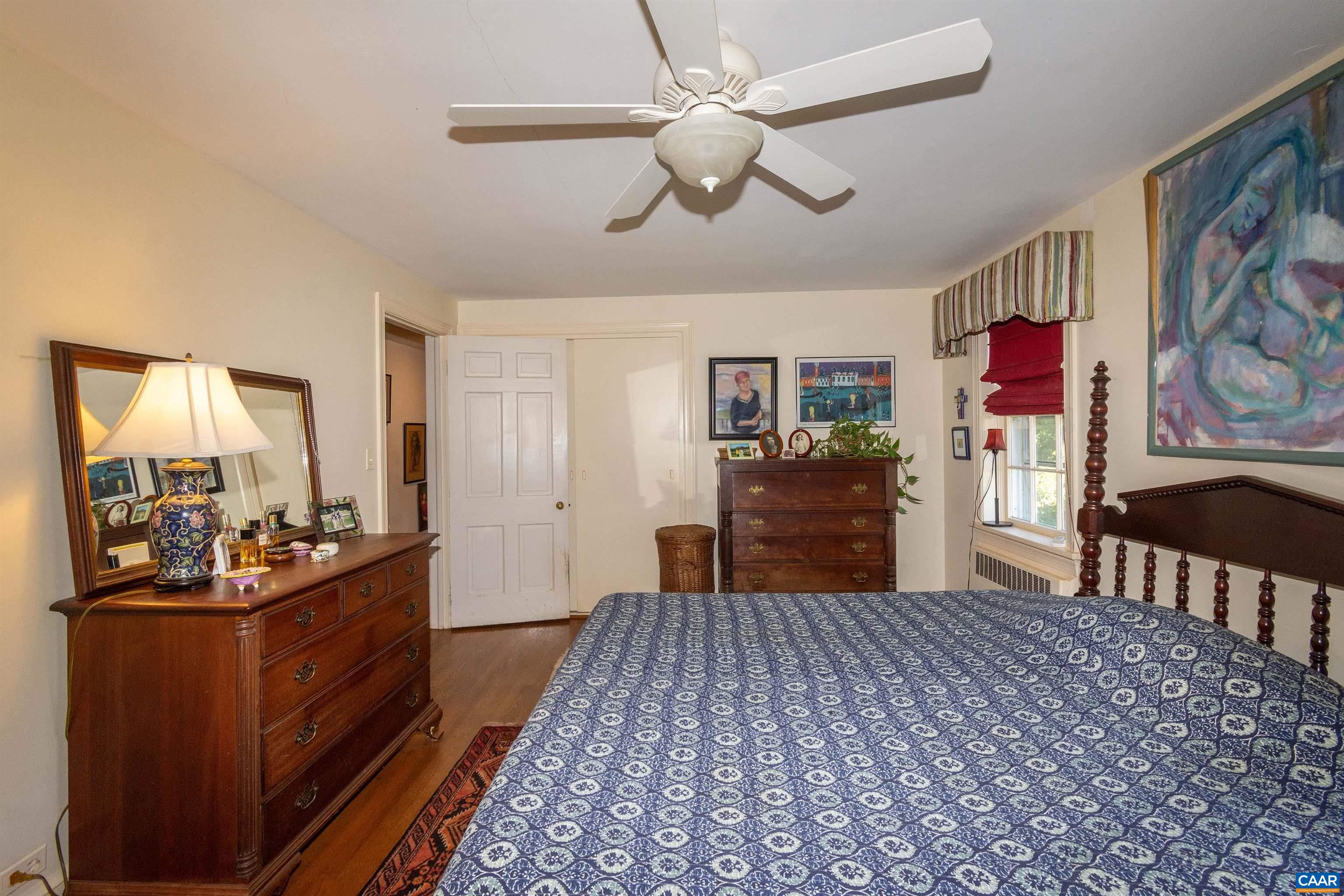 358 East Main Street Orange, VA 22960 - Photo 17 of 56 a bed room with a bed a dresser and book shelfs