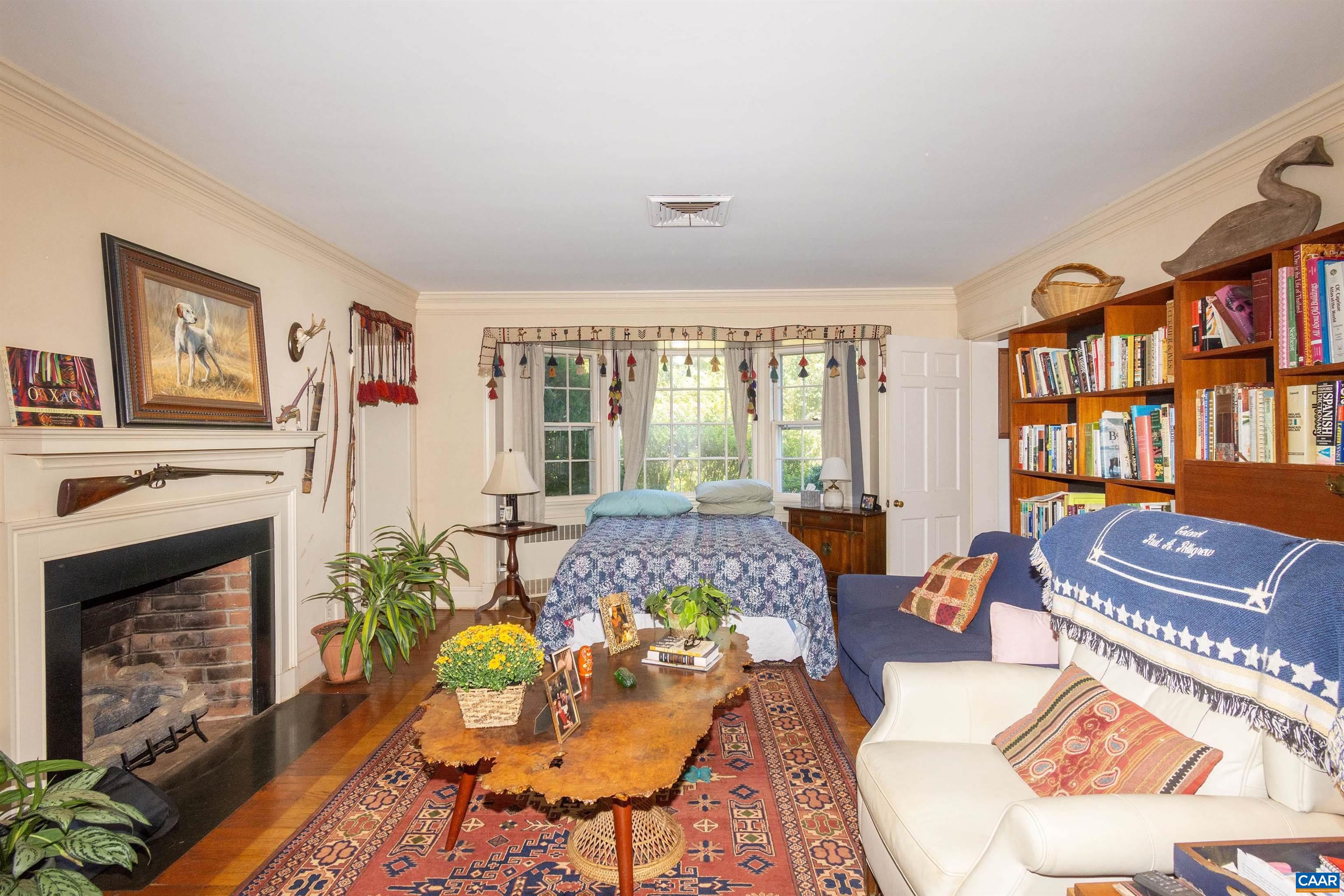 358 East Main Street Orange, VA 22960 - Photo 20 of 56 a living room with furniture a bookshelf and a fireplace