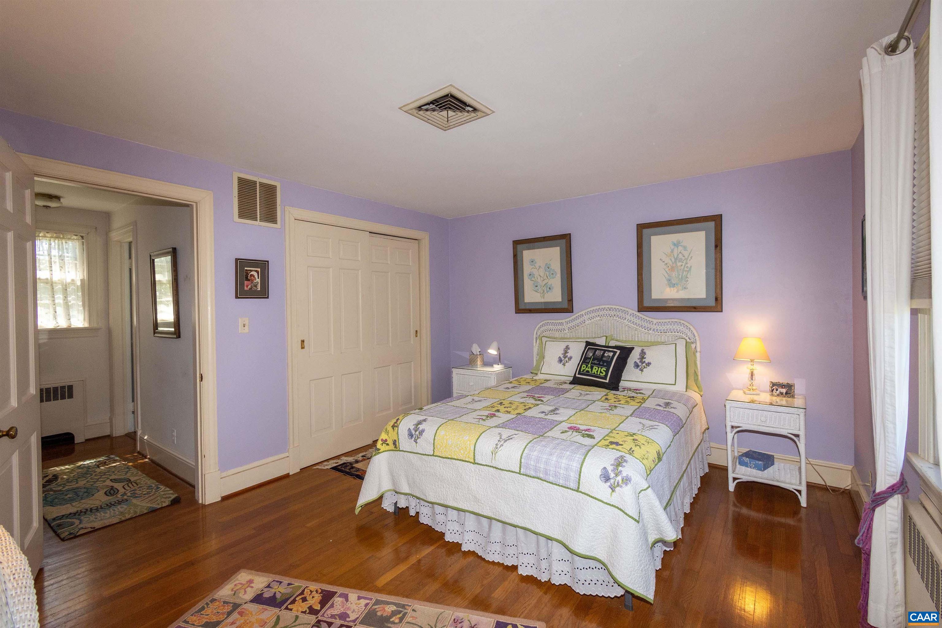 358 East Main Street Orange, VA 22960 - Photo 29 of 56 a bedroom with a bed and a chandelier