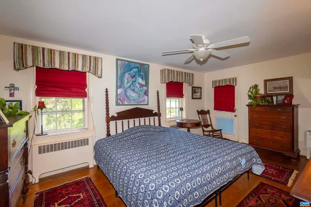 a living room with furniture a rug and a large window