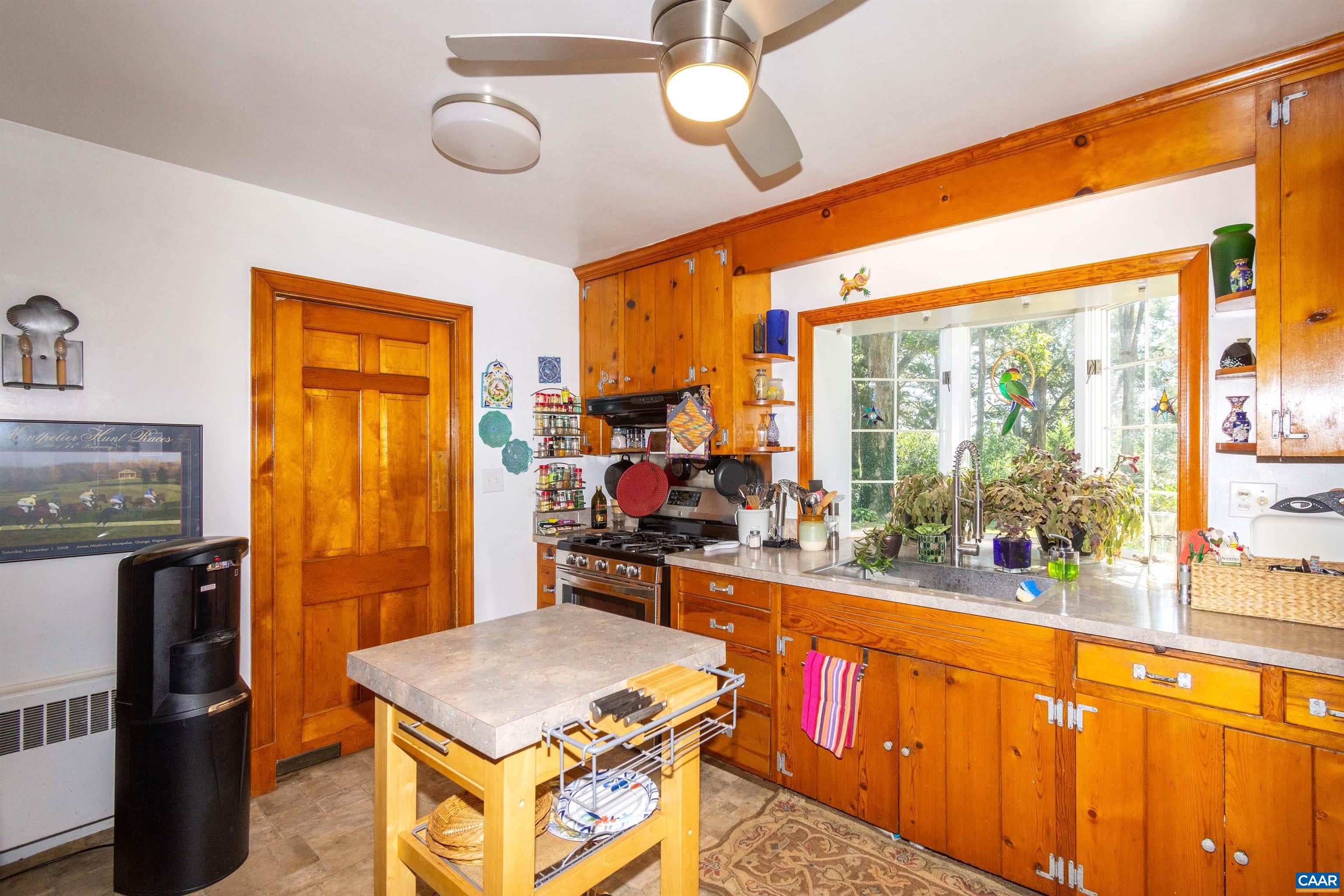 358 East Main Street Orange, VA 22960 - Photo 40 of 56 a kitchen with stainless steel appliances granite countertop a stove top oven