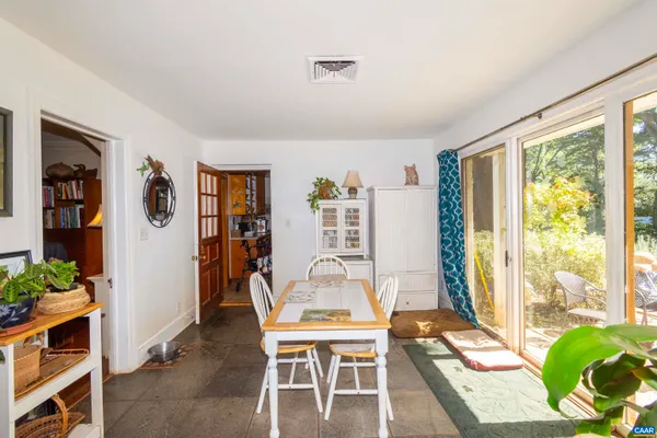 a living room with furniture a fireplace and a large window