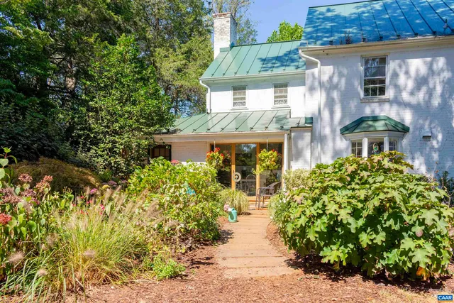 a living room with furniture a rug and a fireplace