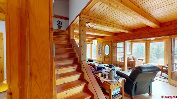 a bed room with two beds next to a window