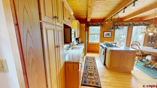 a kitchen with a stove a sink and a refrigerator