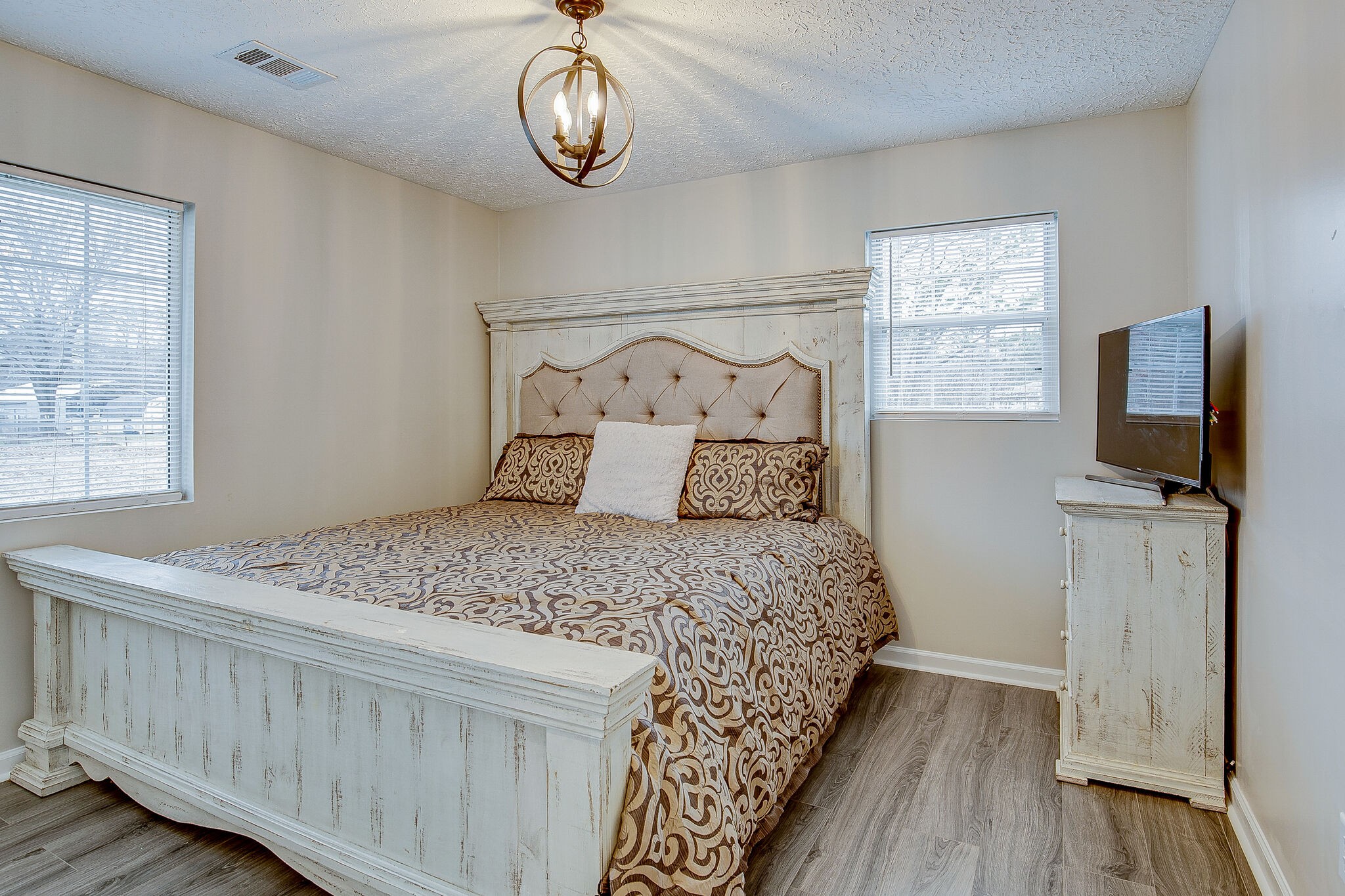 331 Alice Boynton Road Manchester, TN 37355 - Photo 13 of 22 a bedroom with a bed and a flat tv screen on the dresser