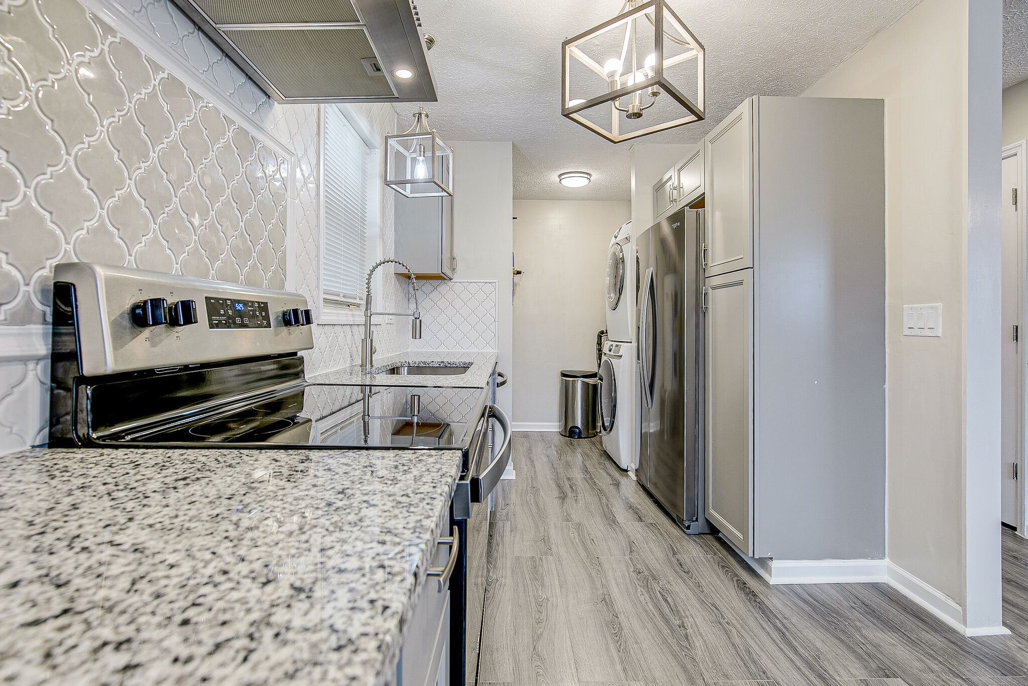 331 Alice Boynton Road Manchester, TN 37355 - Photo 8 of 22 a kitchen with stainless steel appliances a refrigerator a oven a sink dishwasher and white cabinets with wooden floor