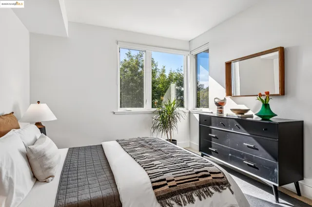 a bedroom with bed and a window