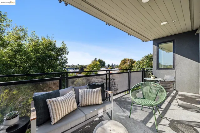 a balcony with table and chairs