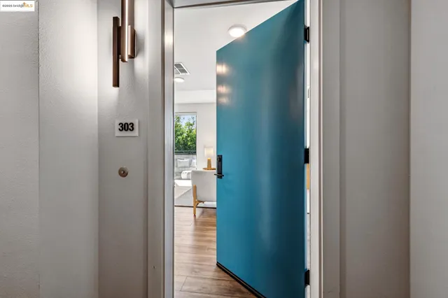 a living room with furniture kitchen view and a window