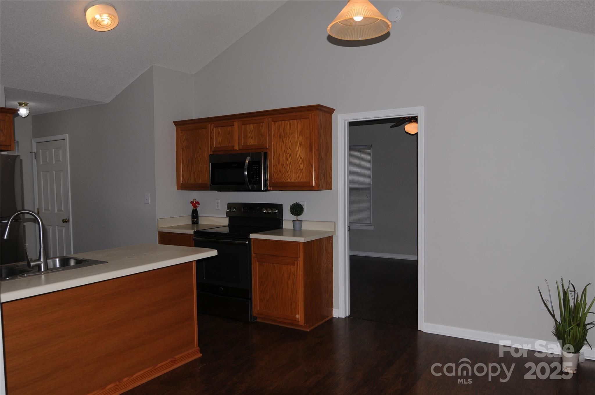 163 Planters Row Road Iron Station, NC 28080 - Photo 11 of 33 a kitchen with stainless steel appliances granite countertop a sink a stove top oven a counter space and cabinets