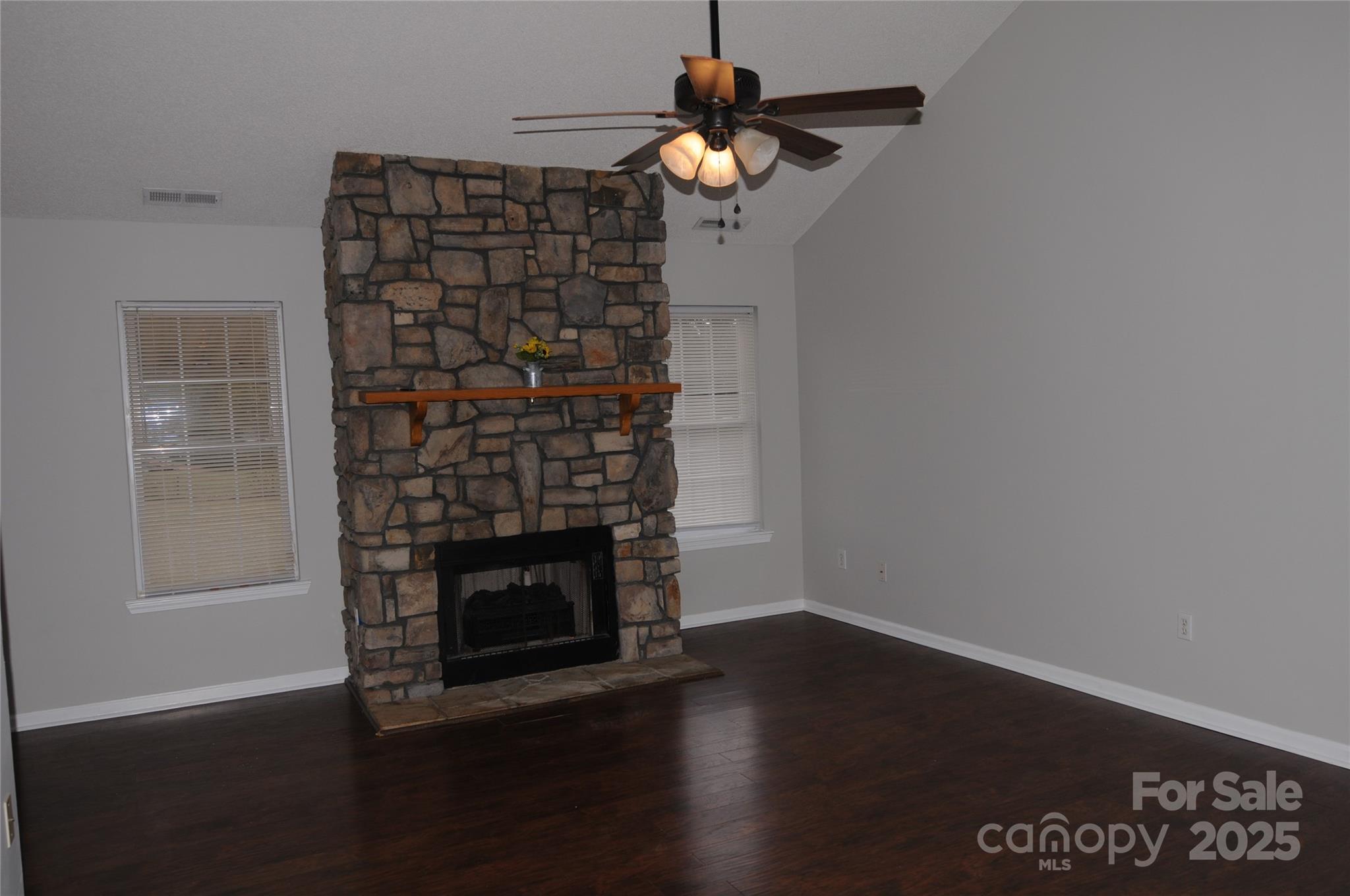 163 Planters Row Road Iron Station, NC 28080 - Photo 13 of 33 a room with a fireplace and wooden floor