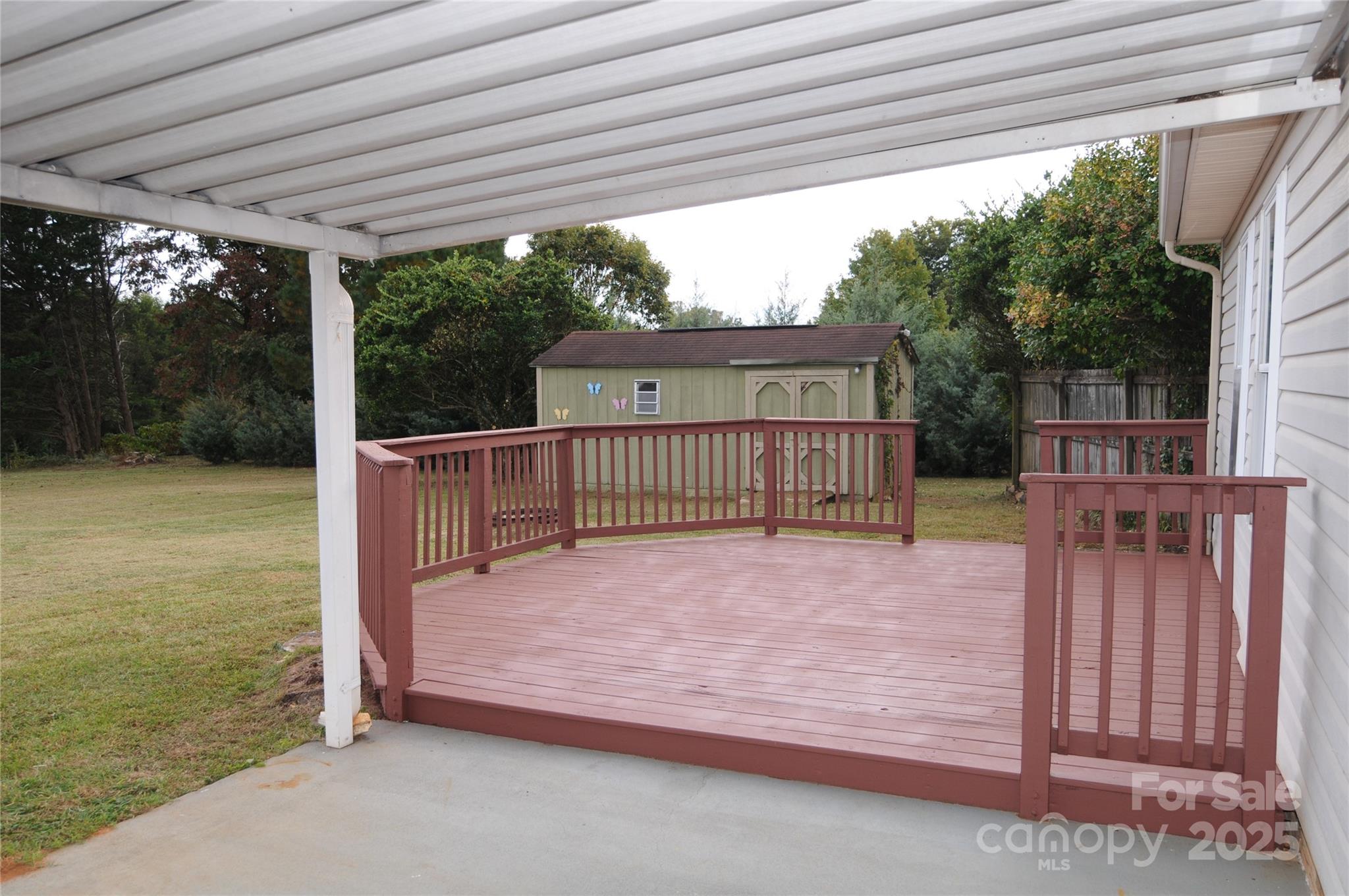 163 Planters Row Road Iron Station, NC 28080 - Photo 14 of 33 a view of a backyard with wooden floor and iron fence