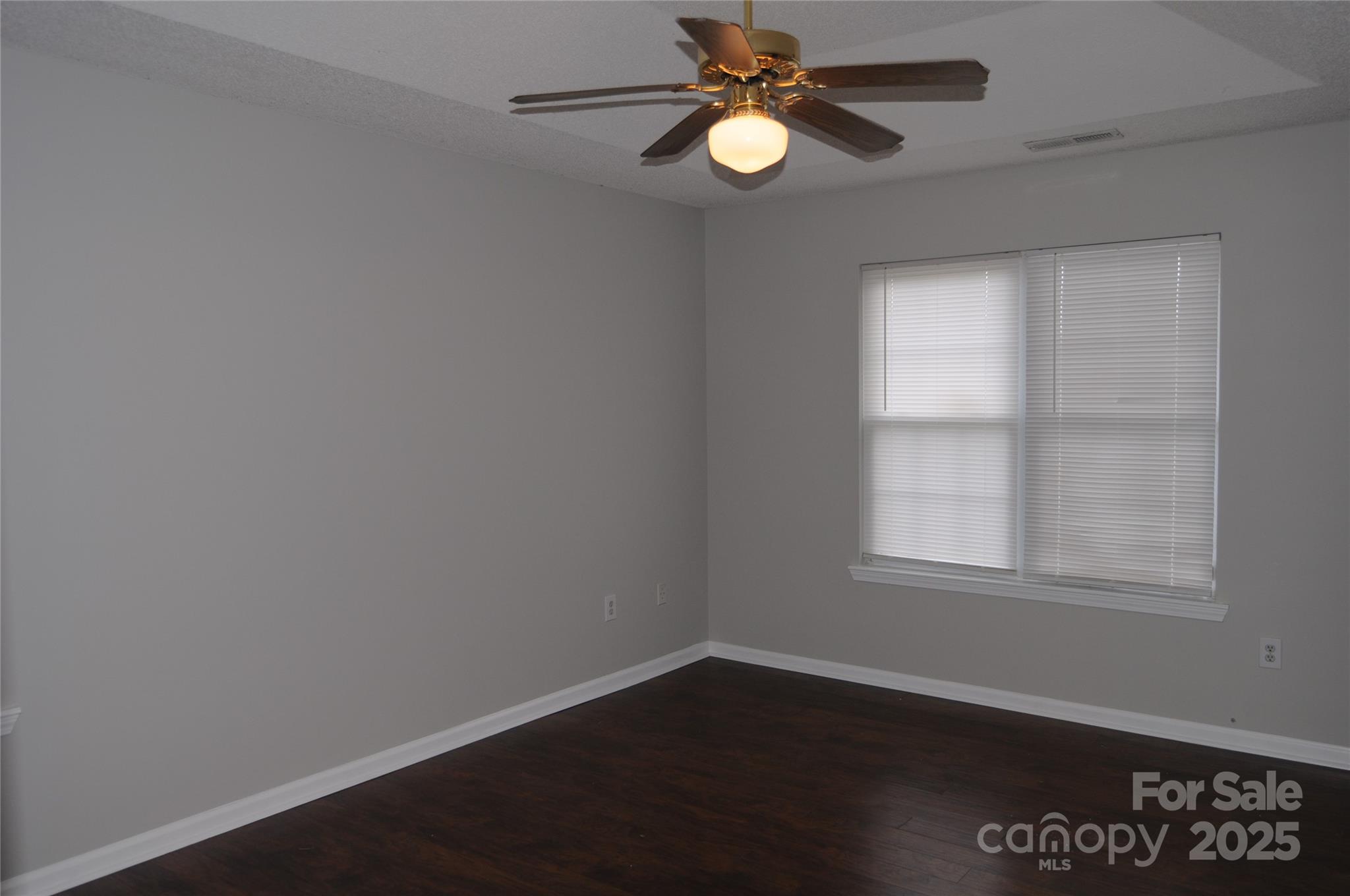 163 Planters Row Road Iron Station, NC 28080 - Photo 20 of 33 an empty room with wooden floor and windows