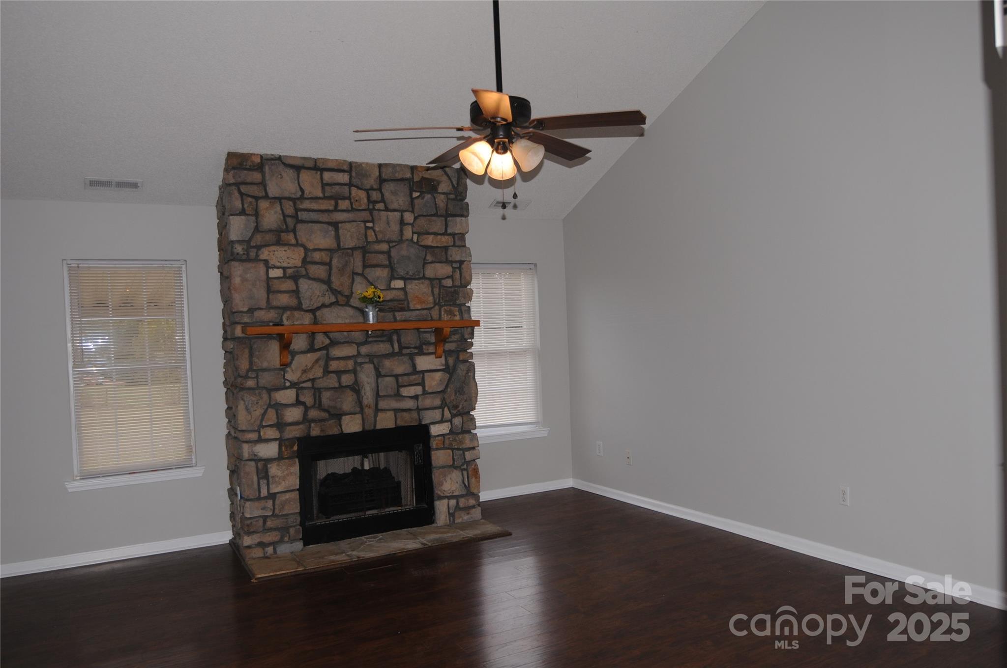163 Planters Row Road Iron Station, NC 28080 - Photo 25 of 33 a living room with a fireplace furniture a ceiling fan and a window