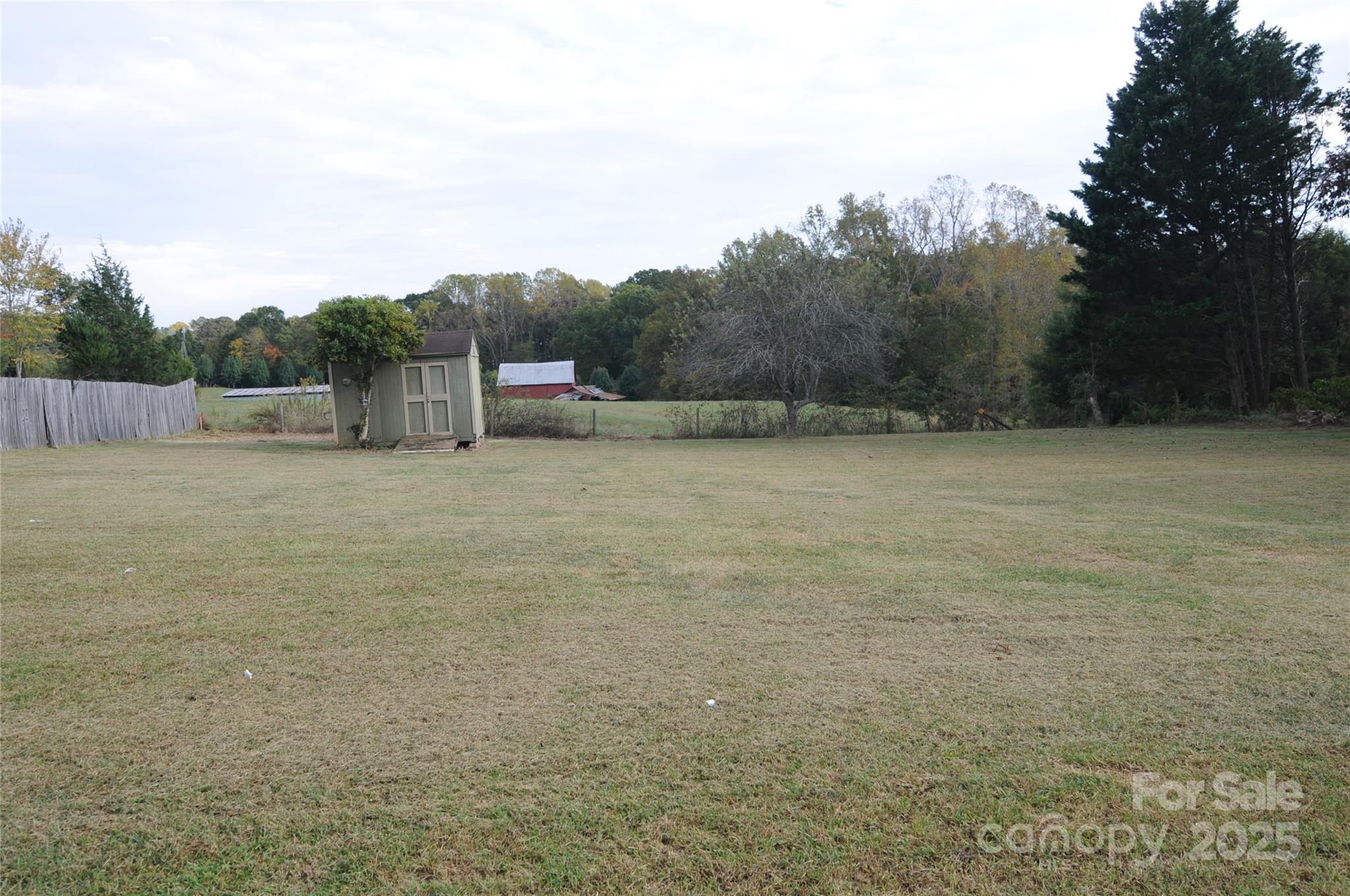 163 Planters Row Road Iron Station, NC 28080 - Photo 30 of 33 a view of a field with trees in the background