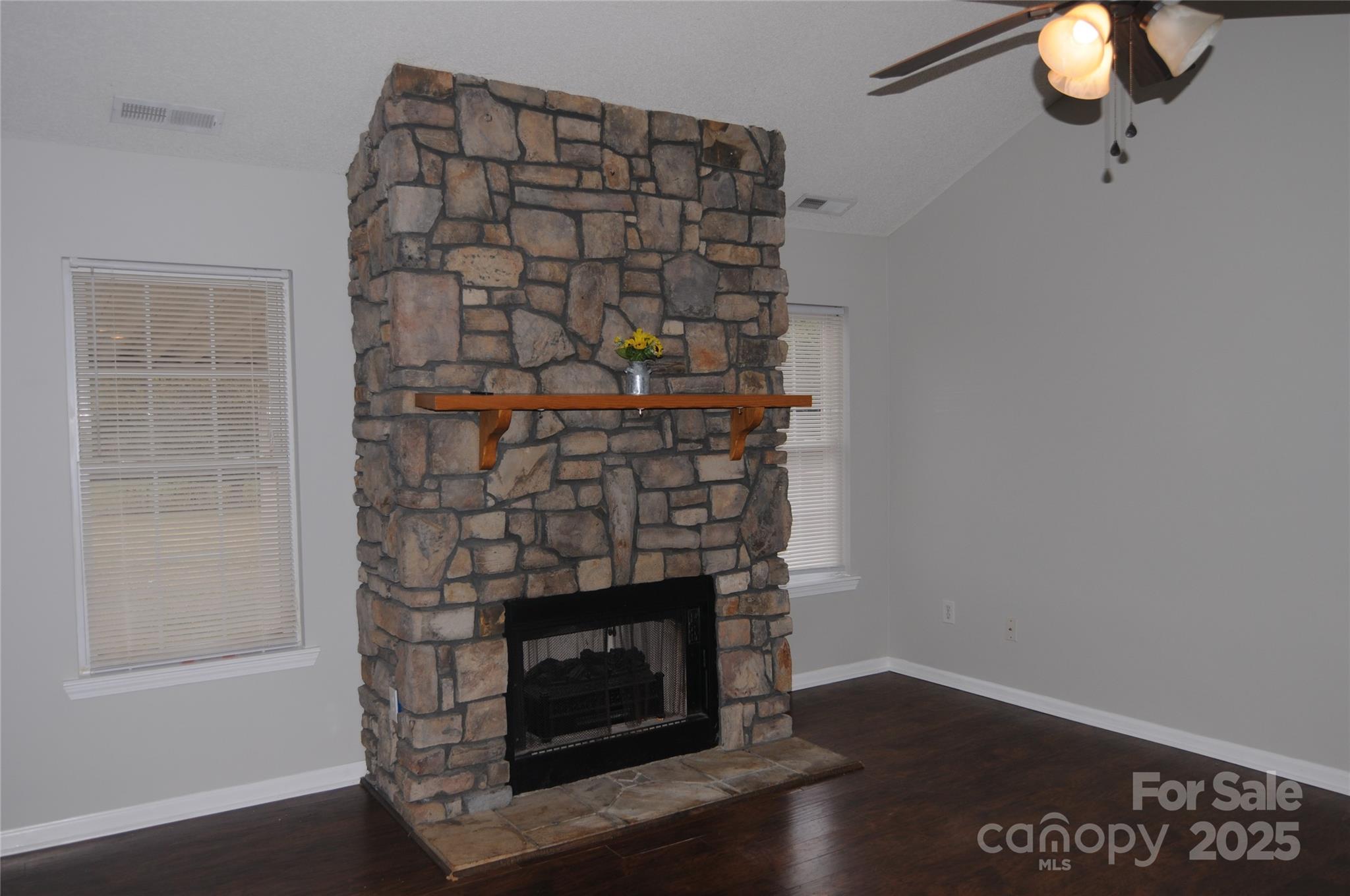 163 Planters Row Road Iron Station, NC 28080 - Photo 5 of 33 a room with a fireplace and cabinets