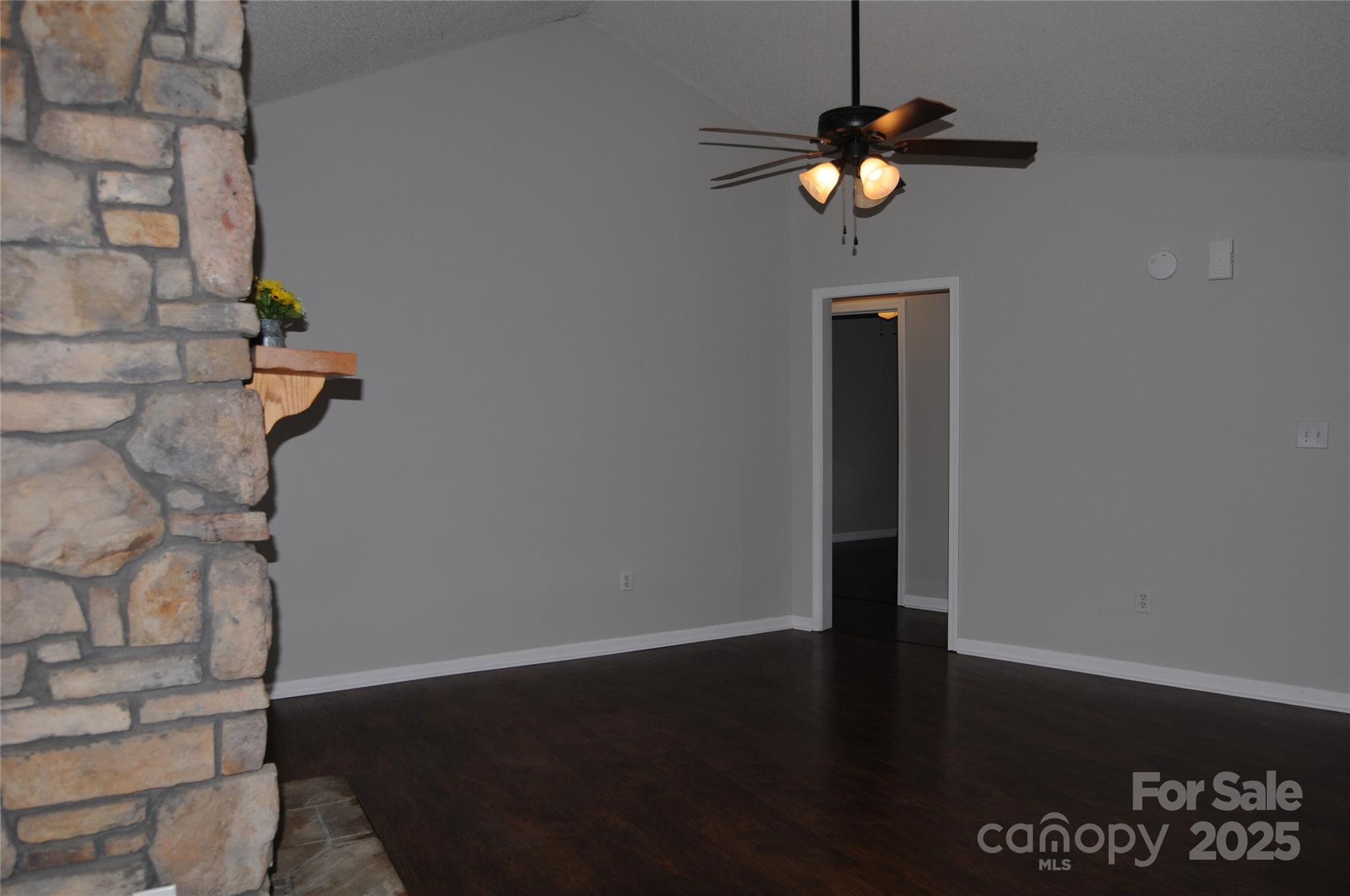 163 Planters Row Road Iron Station, NC 28080 - Photo 7 of 33 a view of a hallway with wooden floor and a chandelier fan