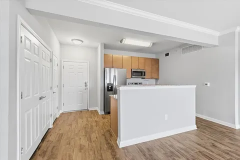 a view of a kitchen with wooden floor