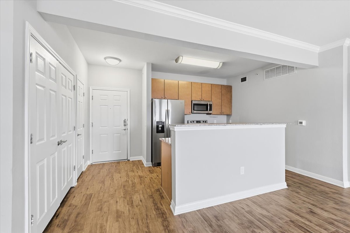2502 Leon Street, Unit 414 Austin, TX 78705 - Photo 4 of 21 a view of a kitchen with wooden floor