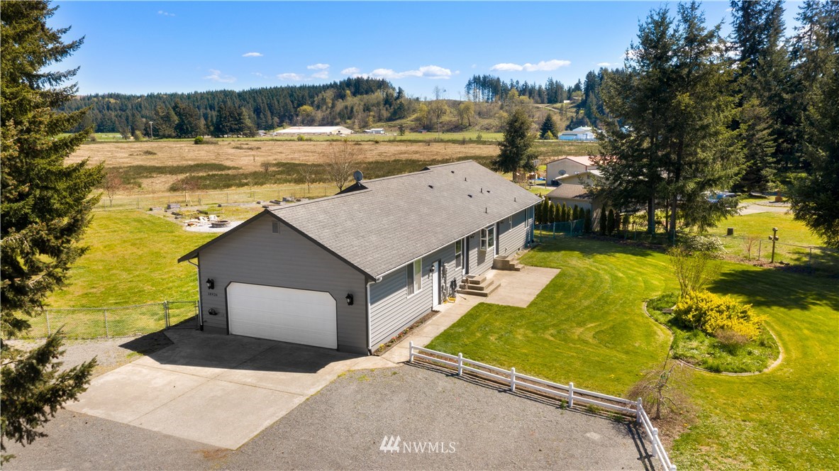 18926 Nutmeg Street Southwest Rochester, WA 98579 - Photo 1 of 23 a view of a house with a yard a house swimming pool and outdoor space