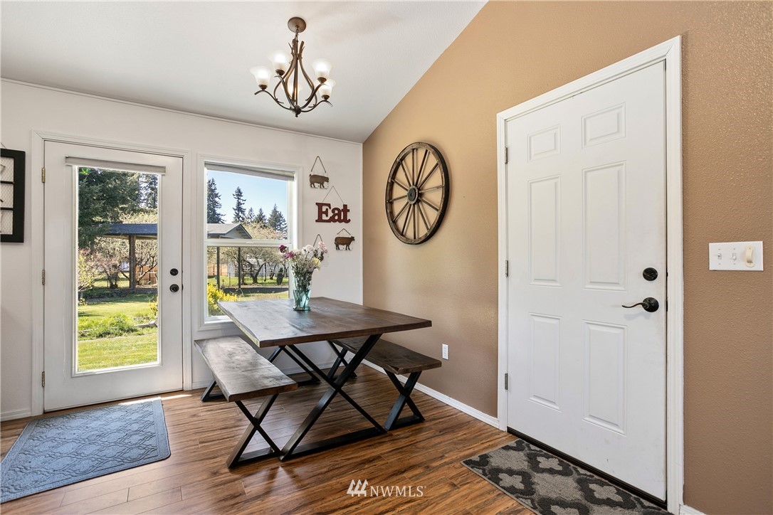 18926 Nutmeg Street Southwest Rochester, WA 98579 - Photo 12 of 23 a view of a dining room with furniture window and wooden floor