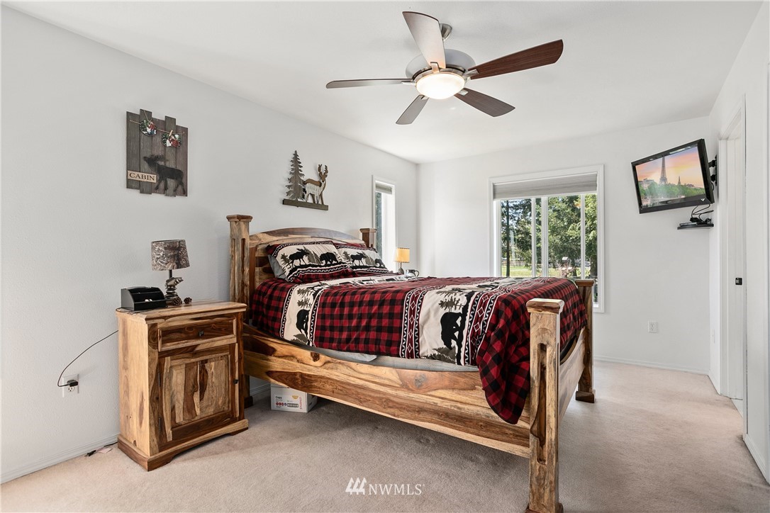18926 Nutmeg Street Southwest Rochester, WA 98579 - Photo 13 of 23 a bedroom with a bed and a chandelier