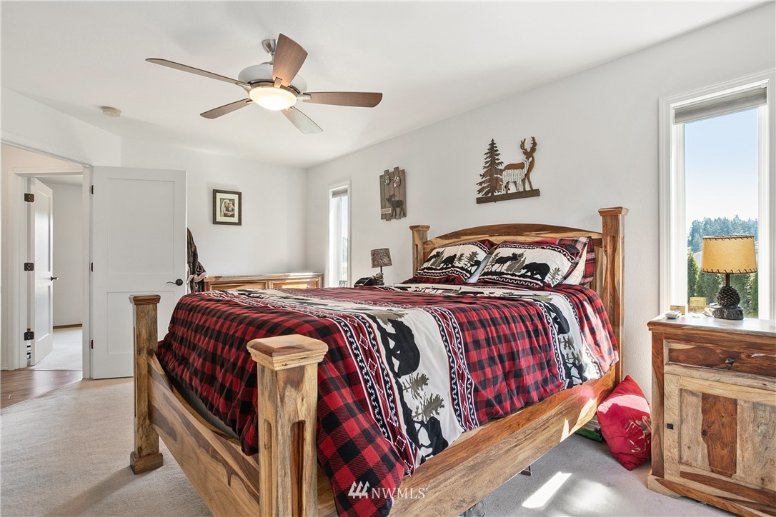 18926 Nutmeg Street Southwest Rochester, WA 98579 - Photo 14 of 23 a bedroom with a bed and a chandelier