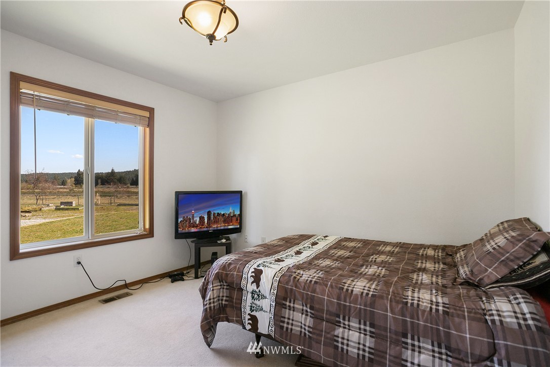 18926 Nutmeg Street Southwest Rochester, WA 98579 - Photo 15 of 23 a bedroom with a bed and window