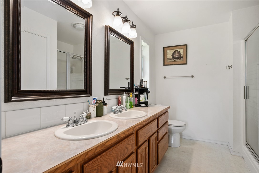 18926 Nutmeg Street Southwest Rochester, WA 98579 - Photo 17 of 23 a bathroom with a double vanity sink and a mirror